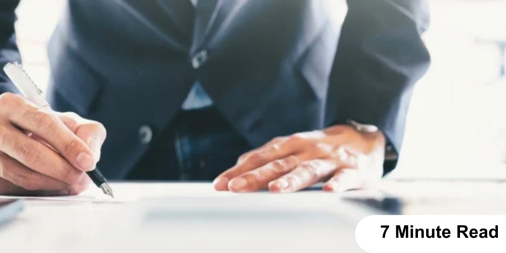 A man signing a paper